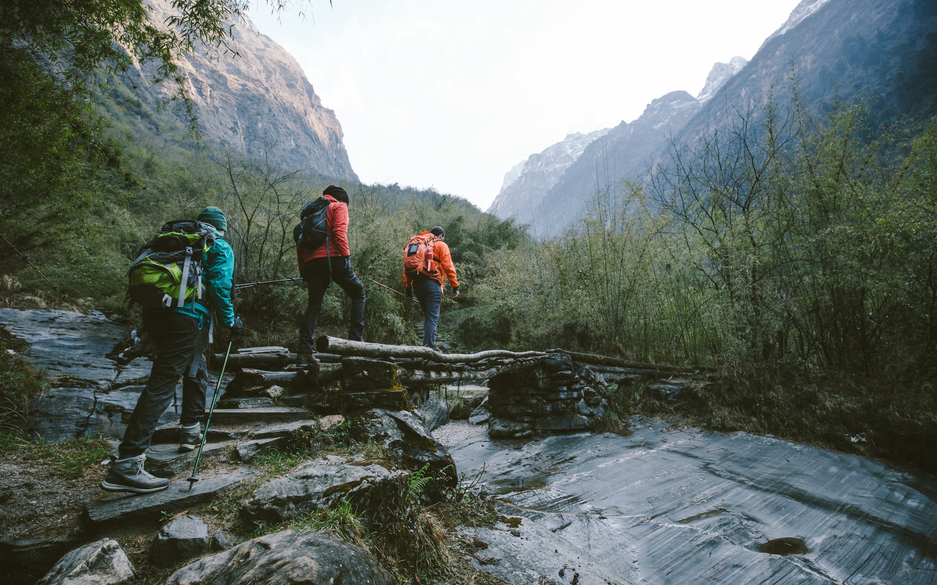 Backpackers crossing a mountain stream
